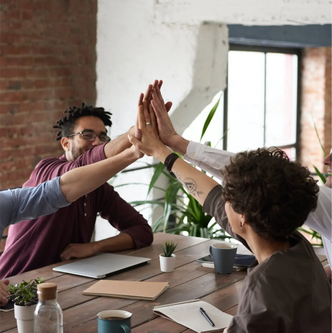 People high five-ing while sitting on office chair